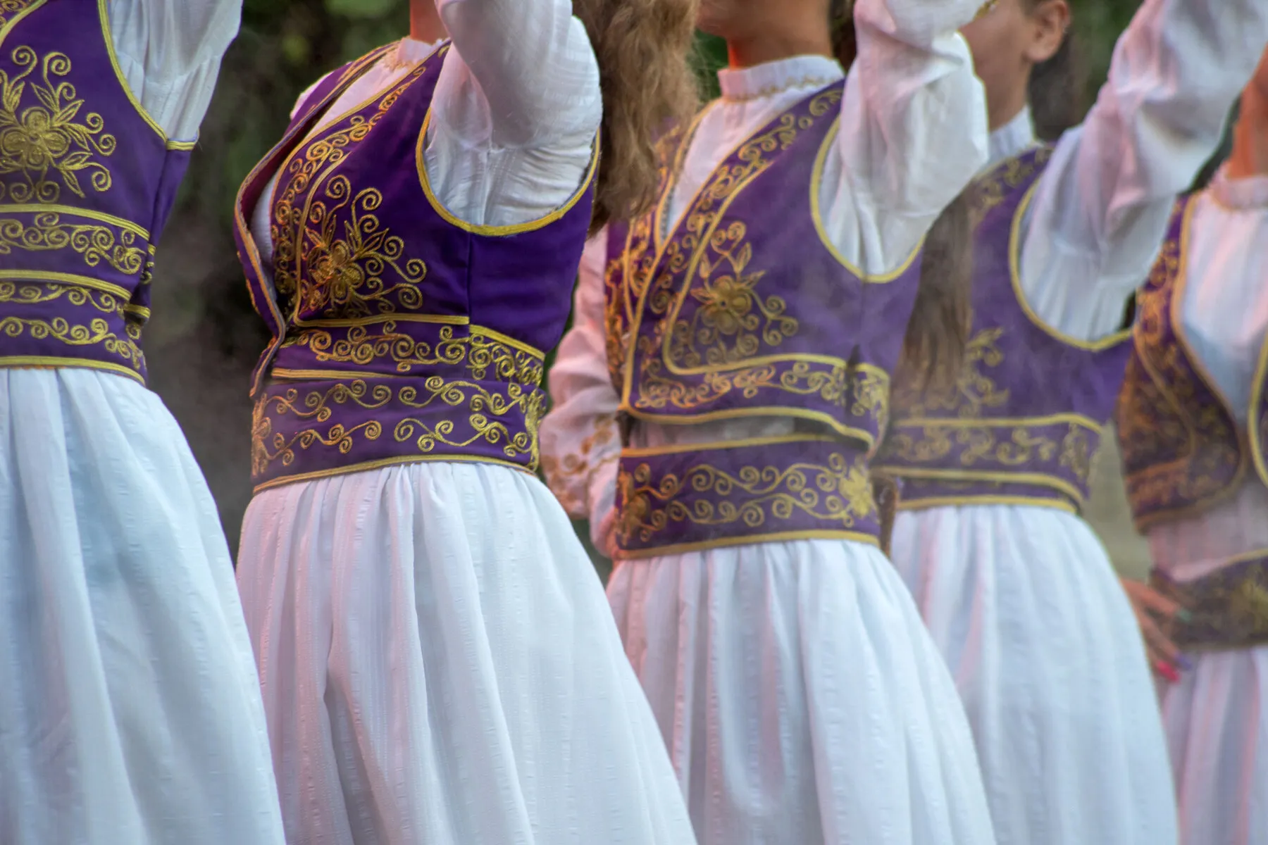 A line of dancers in traditional Albanian costume